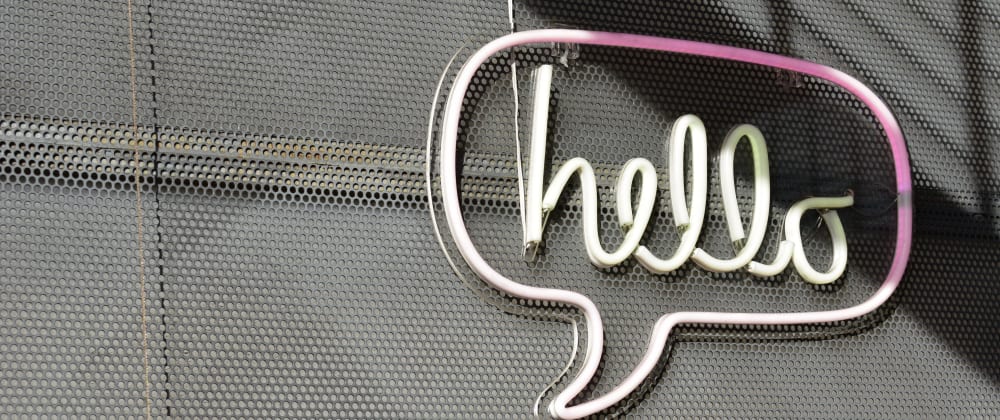 sign hung on a wall showing hello written in a comment bubble