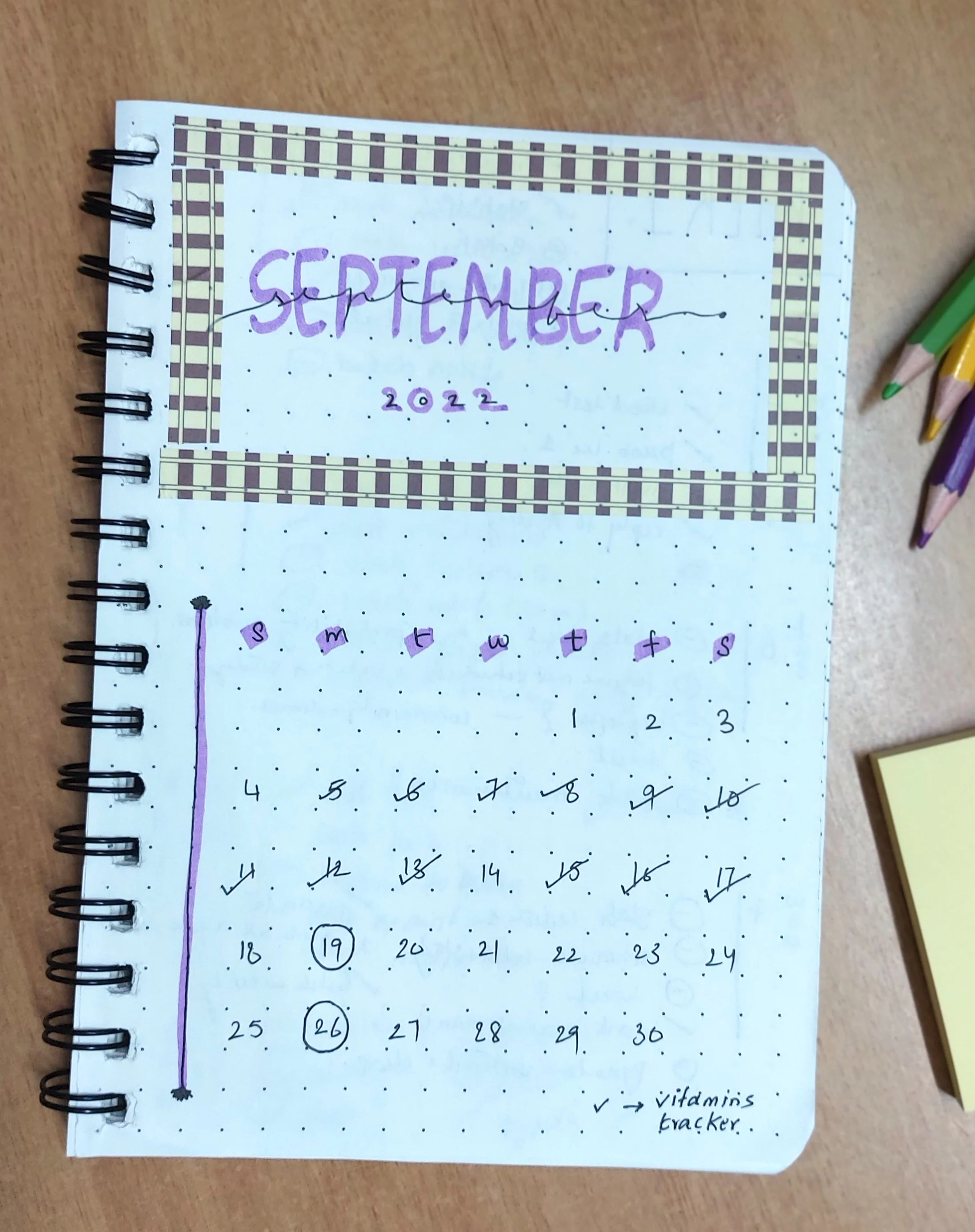 In the top half, &lsquo;September 2022&rsquo; written in big block letters within a border created with decorative tape. Botton half has the monthly calendar with some dates ticked tracking vitamins.