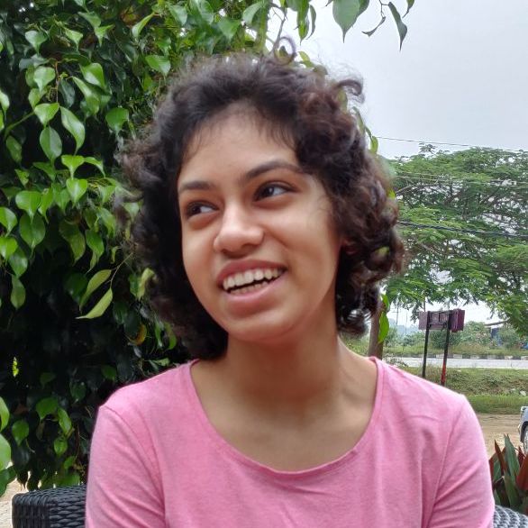Pavithra's picture - An indian woman with short curly hair in a pink top.